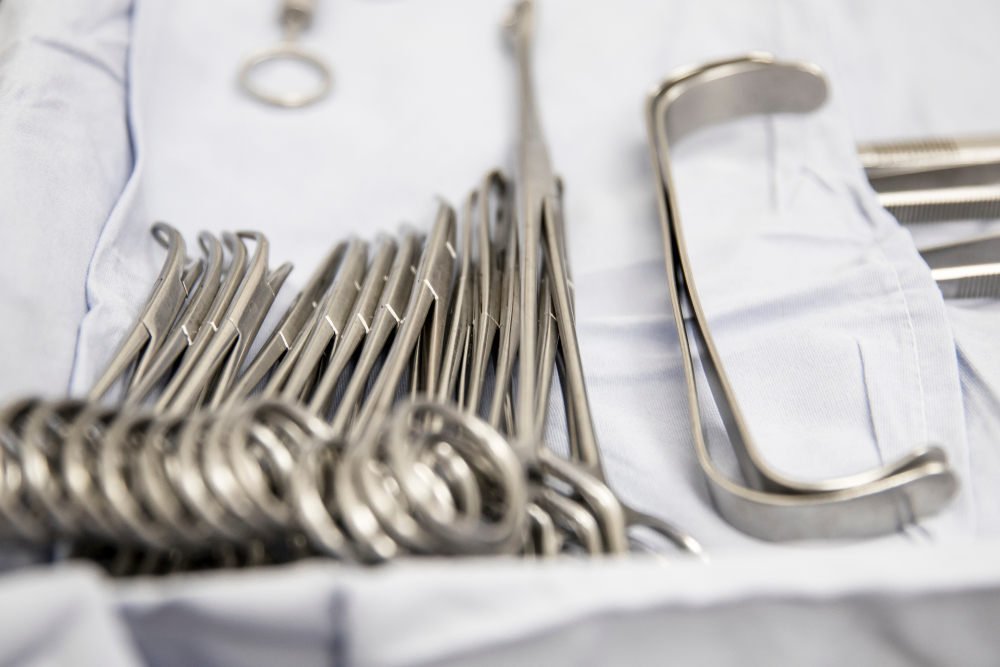 Stainless,Steel,Surgical,Instruments,,Displayed,In,A,Blue,Fabric,Covered