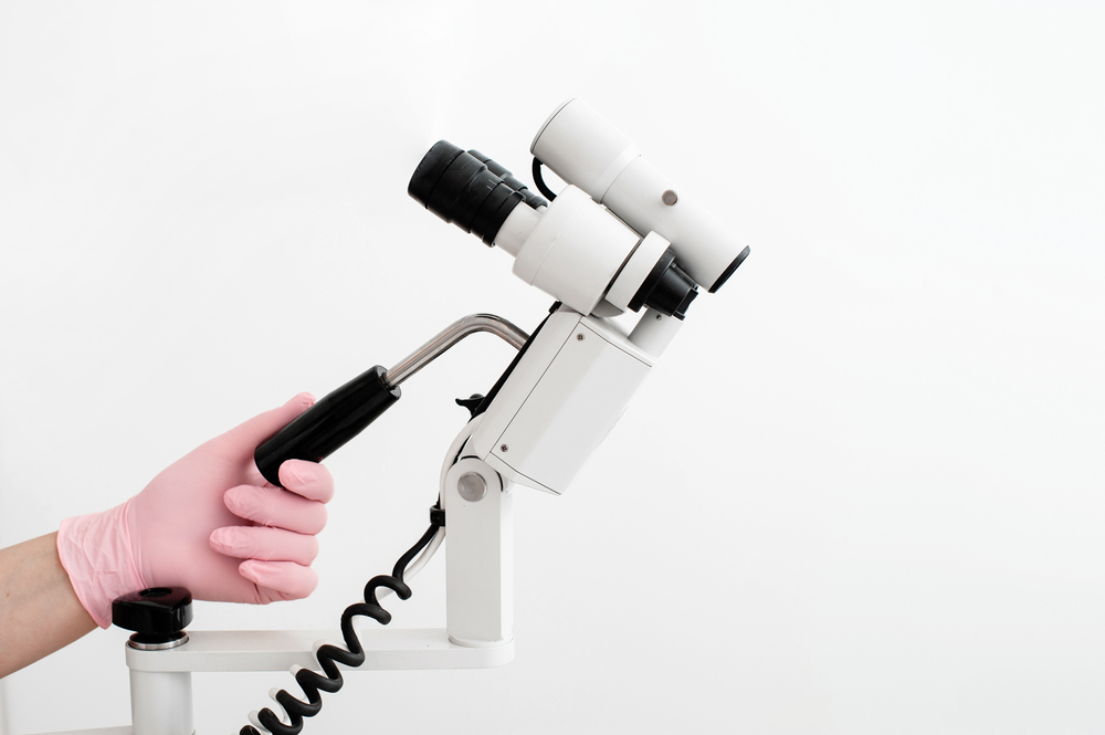 Woman,Gynecologist,In,Pink,Gloves,Working,With,Colposcope,In,Clinic